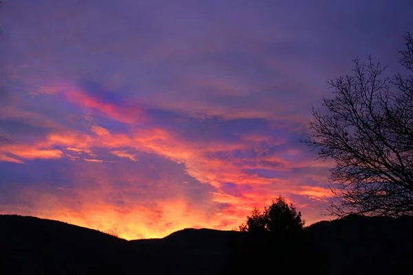 A vivid pink and orange sunset over the ridgeline near Durango