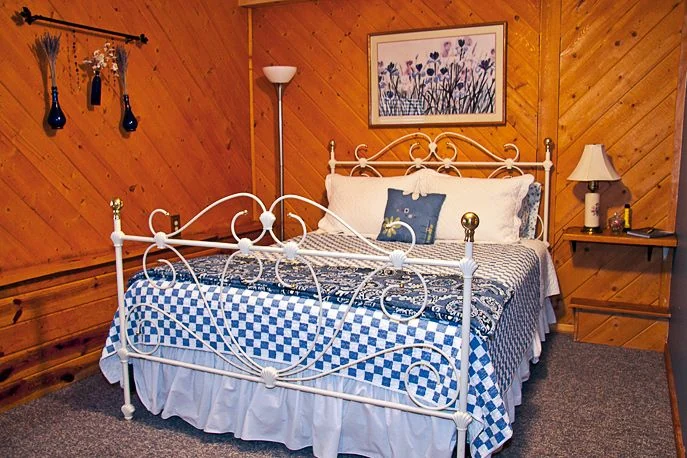 Columbine Room with a brass and white iron bed